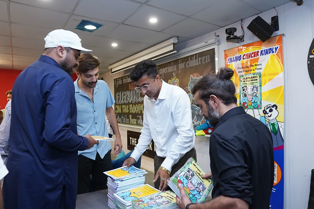 Guests collect copies of the new Killing Cancer Kindly children's comic at the launch.