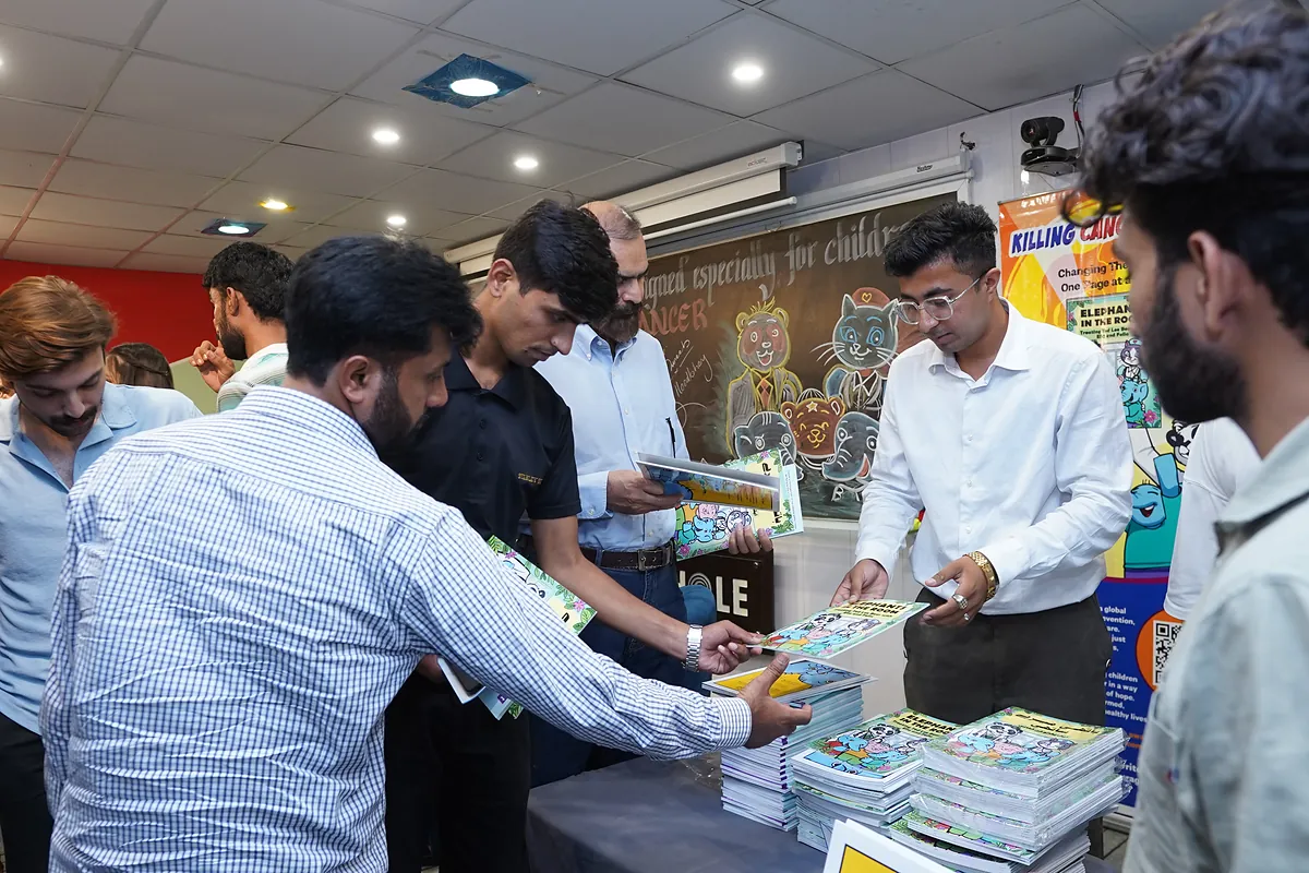 Copies of Elephants in the Room being handed out to guests at the launch event.