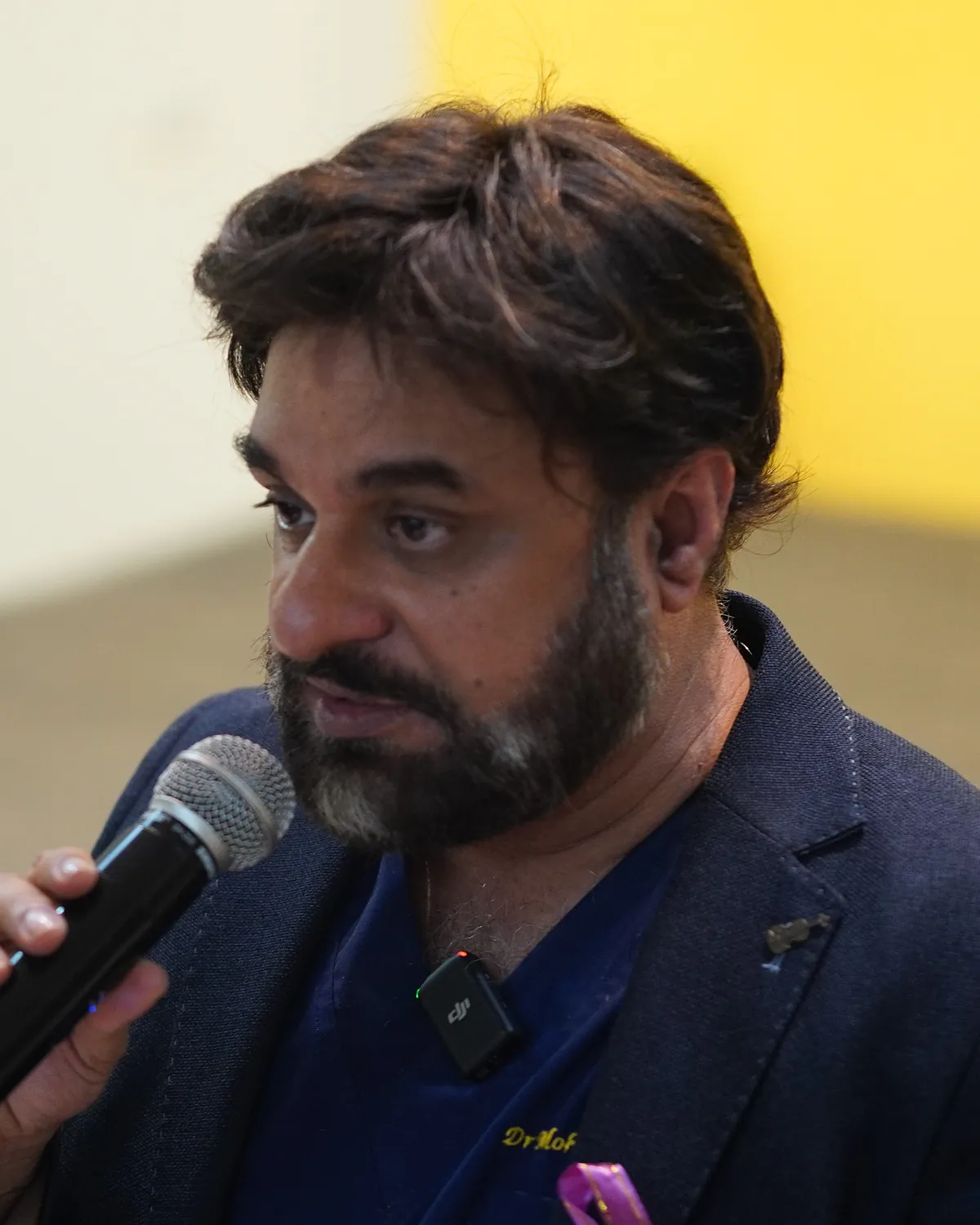Dr Mohammad Muneeb Khan, NHS consultant clinical oncologist and founder of Killing Cancer Kindly, speaking at a school event.