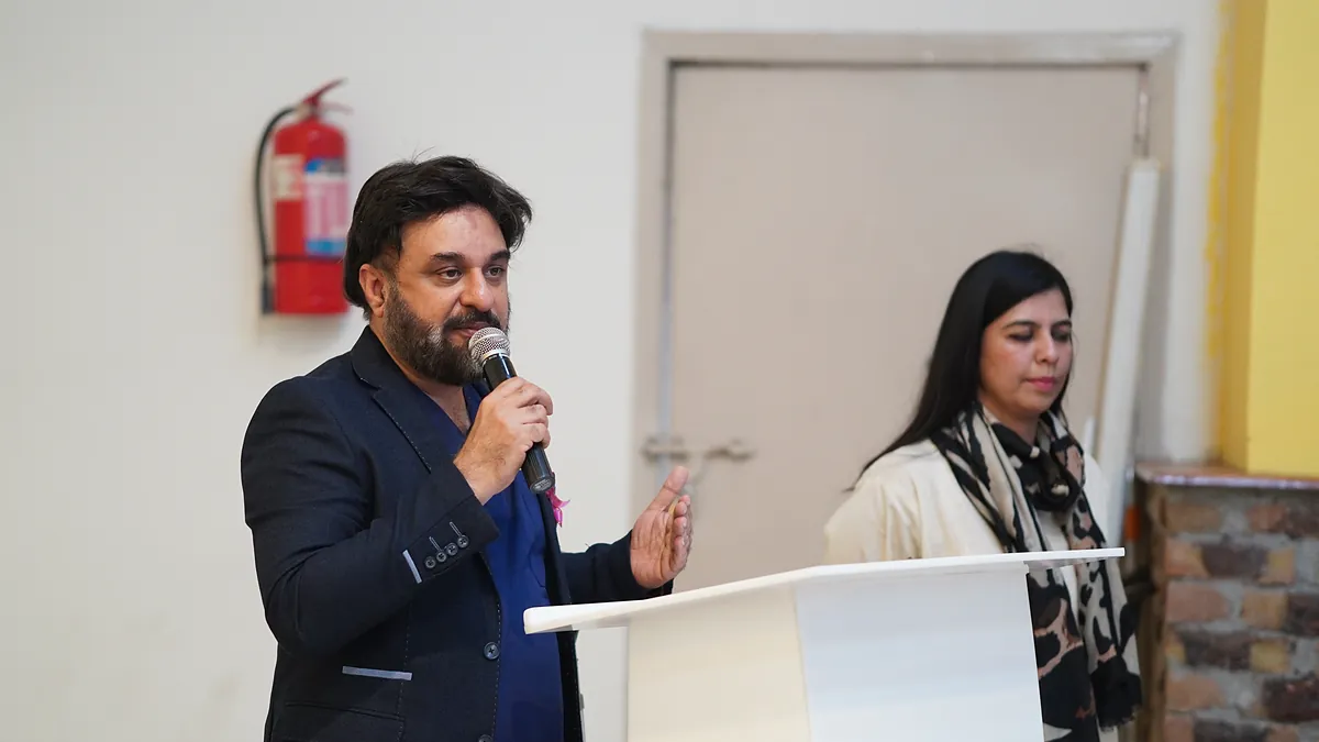 Dr Mohammad Muneeb Khan speaking at a lectern during a cancer-prevention assembly at Beaconhouse School System.