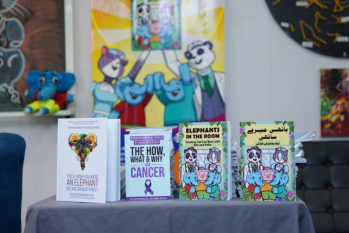 Killing Cancer Kindly books on display, including Elephants in the Room in both its English and Urdu editions.