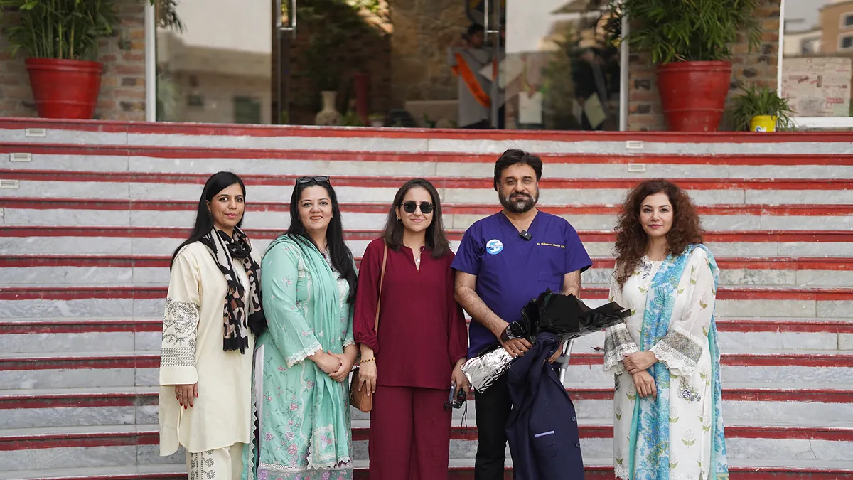 Dr Mohammad Muneeb Khan and the Killing Cancer Kindly outreach team on the school steps after the assembly.